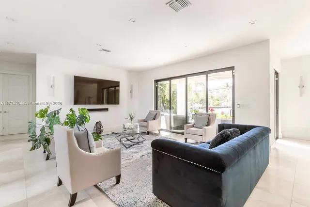a living room with furniture potted plant and a window
