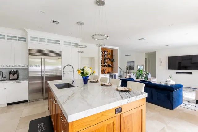 a kitchen with stainless steel appliances granite countertop a sink and cabinets
