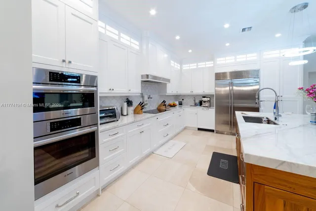 a kitchen with stainless steel appliances granite countertop a stove and a sink