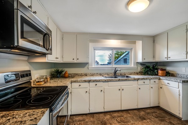 36 Whalom Road Lunenburg, MA 01462 - Photo 10 of 26 a kitchen with granite countertop a stove sink and cabinets