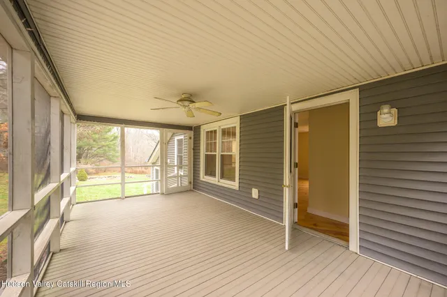a bedroom with furniture and a large window