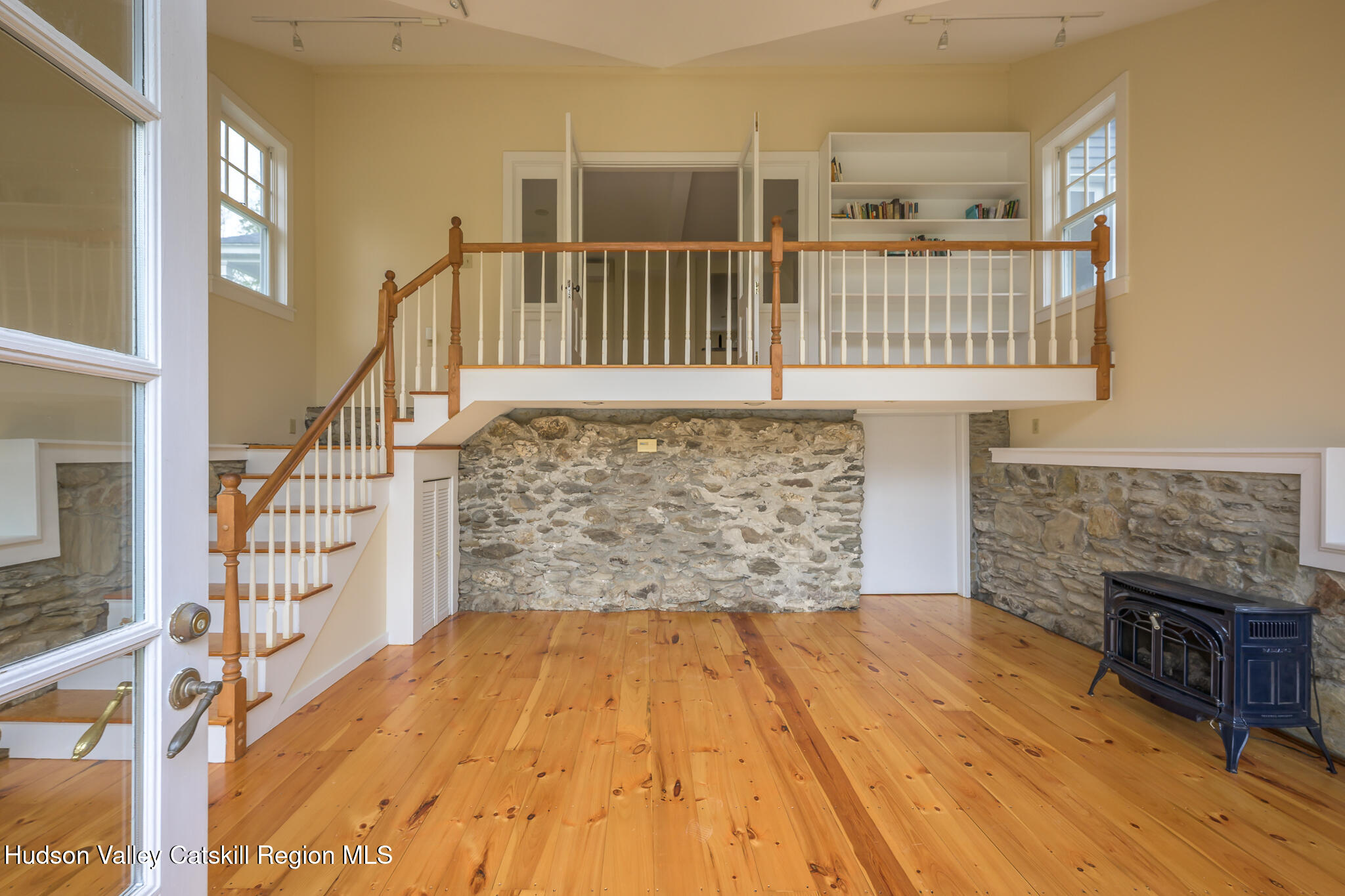 477 Fog Hill Road Austerlitz, NY 12017 - Photo 22 of 33 a view of an empty room with wooden floor and a fireplace
