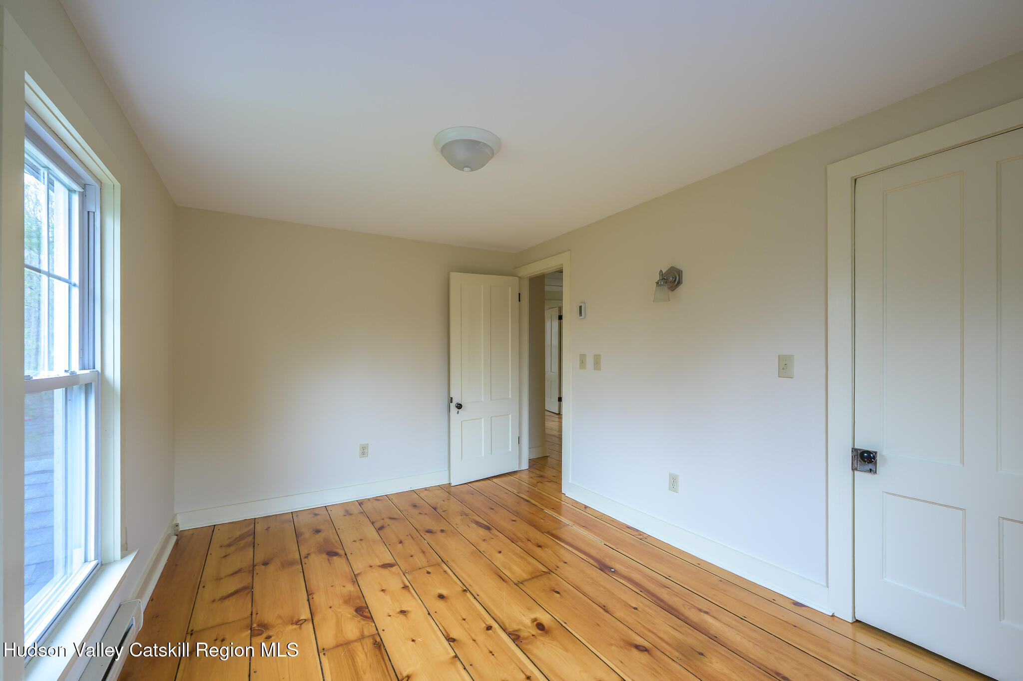 477 Fog Hill Road Austerlitz, NY 12017 - Photo 26 of 33 a view of empty room with wooden floor and fan