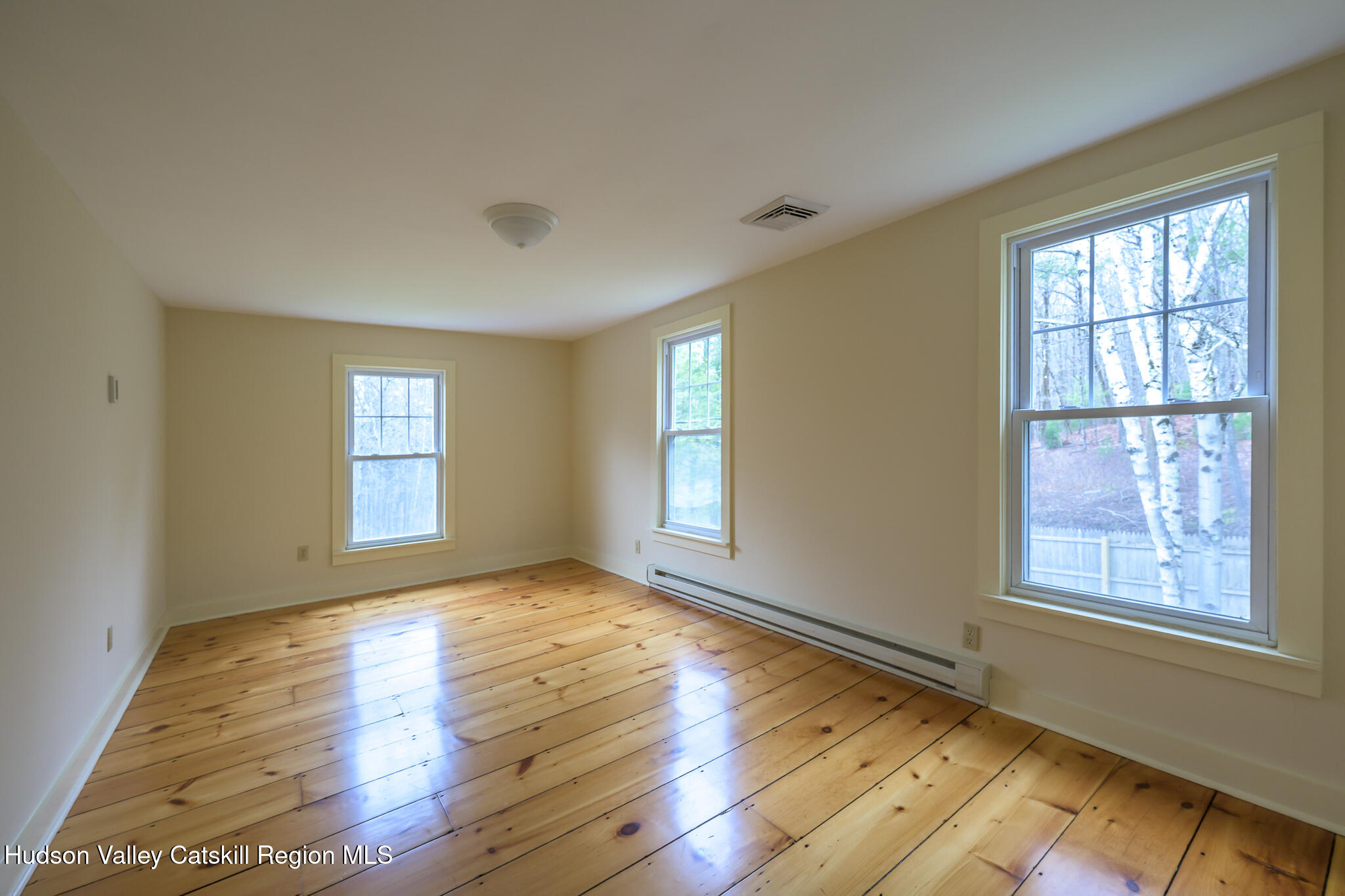 477 Fog Hill Road Austerlitz, NY 12017 - Photo 29 of 33 a view of an empty room with wooden floor and a window