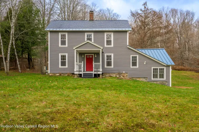 a front view of house with yard and green space