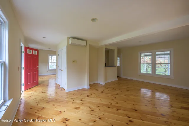 wooden floor in an empty room with a window