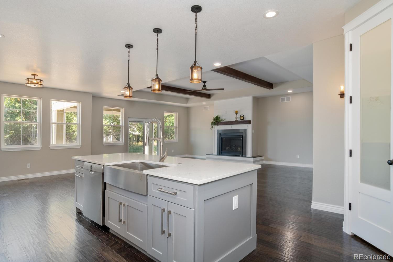 1726 Virginia Drive Fort Lupton, CO 80621 - Photo 12 of 36 a kitchen with a sink a counter space and wooden floor