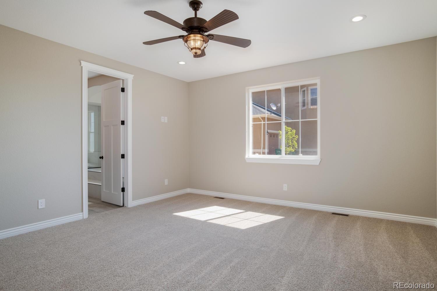 1726 Virginia Drive Fort Lupton, CO 80621 - Photo 15 of 36 an empty room with a window and a fan