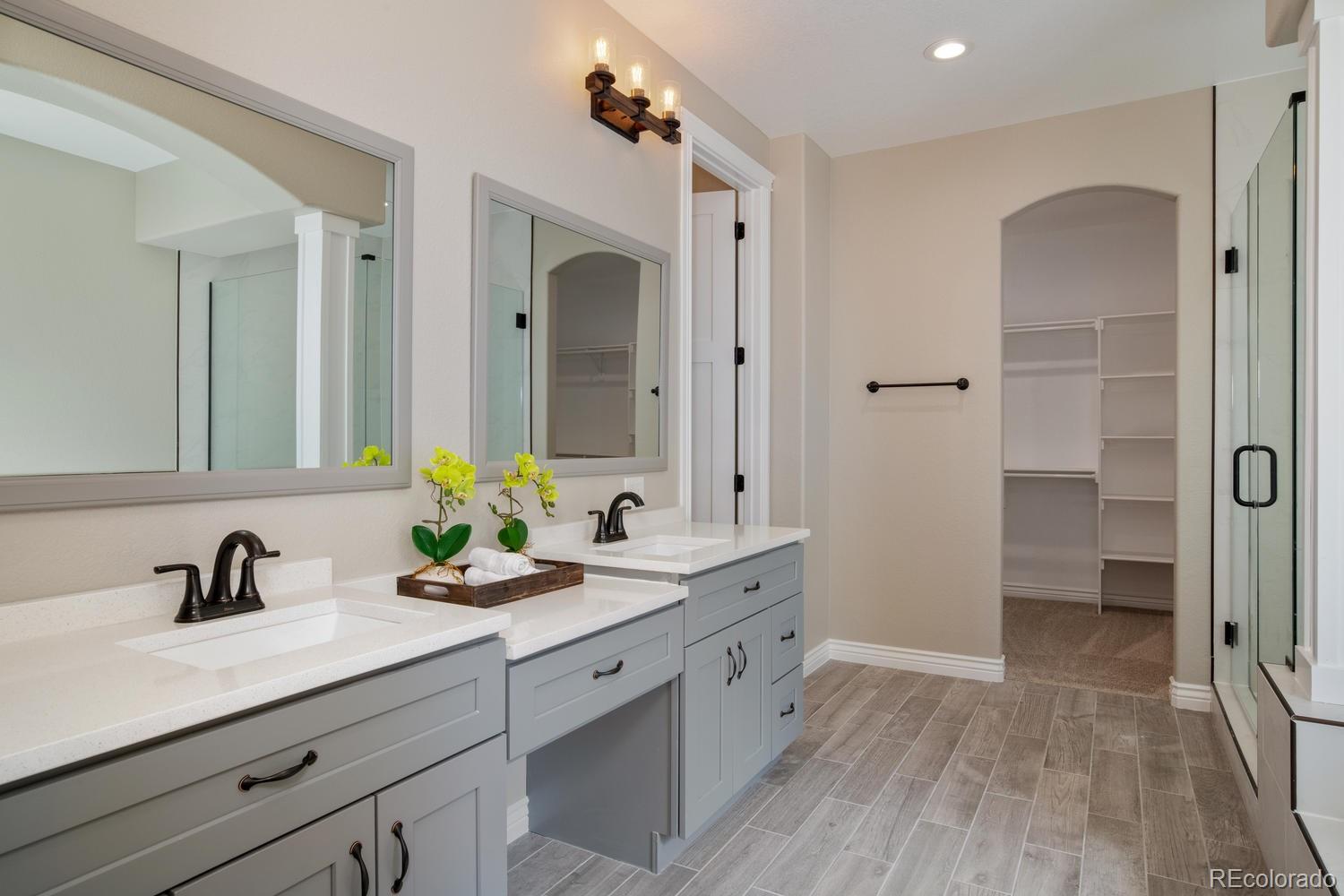 1726 Virginia Drive Fort Lupton, CO 80621 - Photo 17 of 36 a bathroom with a double vanity sink mirror and shower