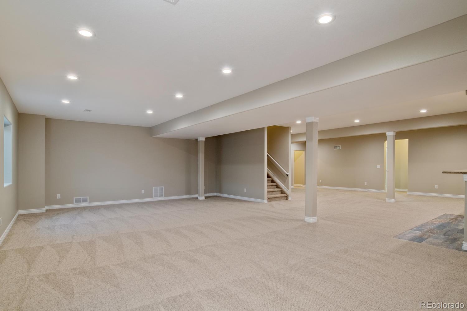 1726 Virginia Drive Fort Lupton, CO 80621 - Photo 27 of 36 an empty room with windows and pillars in it
