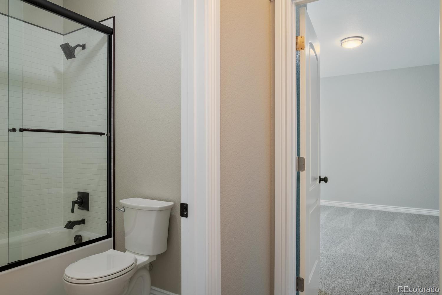 1726 Virginia Drive Fort Lupton, CO 80621 - Photo 32 of 36 a white toilet sitting next to a bathroom sink