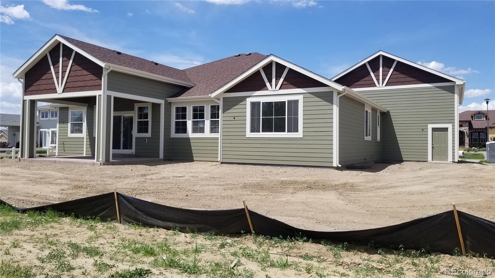 1726 Virginia Drive Fort Lupton, CO 80621 - Photo 36 of 36 a view of a house with wooden roof and wooden fence