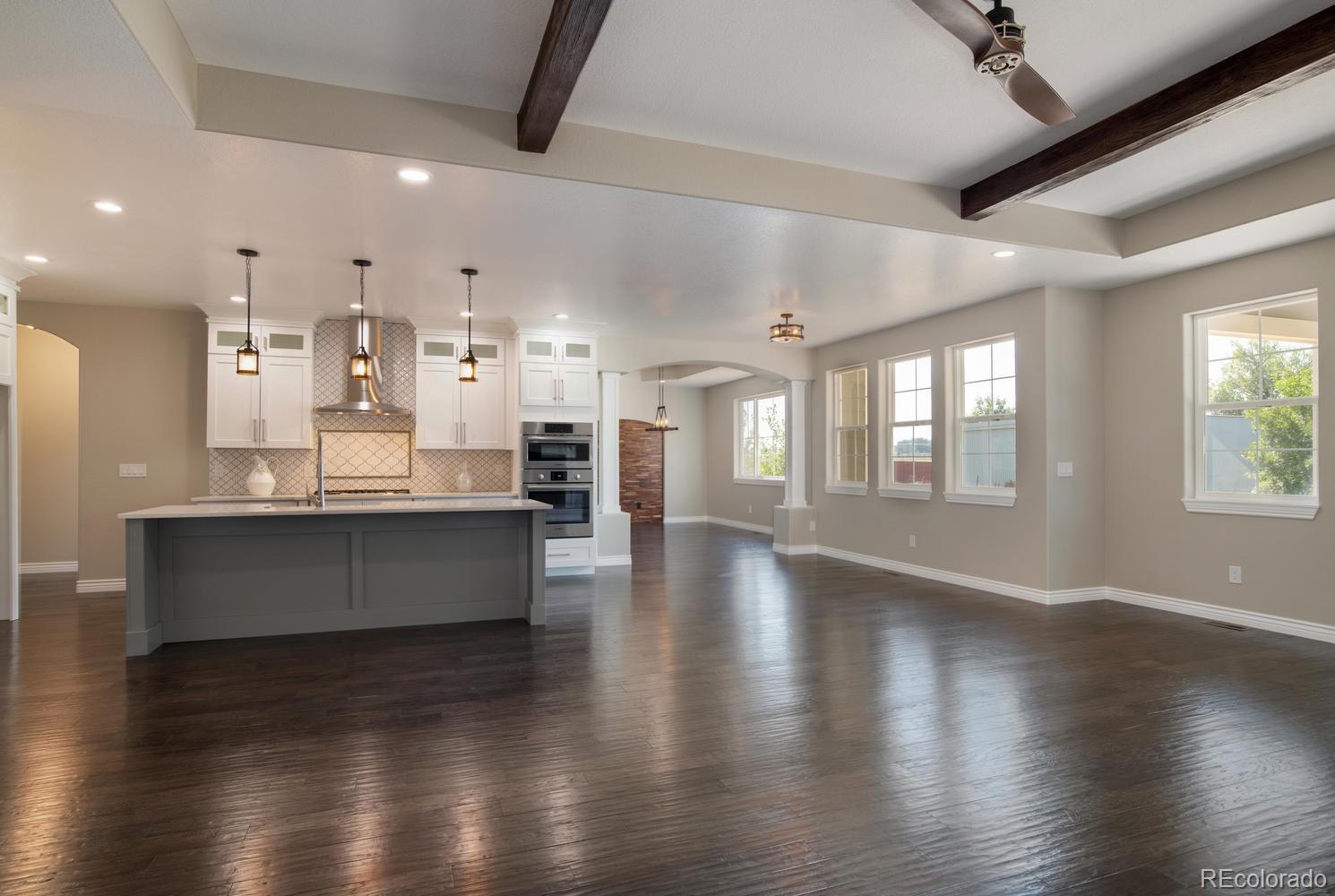1726 Virginia Drive Fort Lupton, CO 80621 - Photo 6 of 36 a large kitchen with hardwood floor and a large window