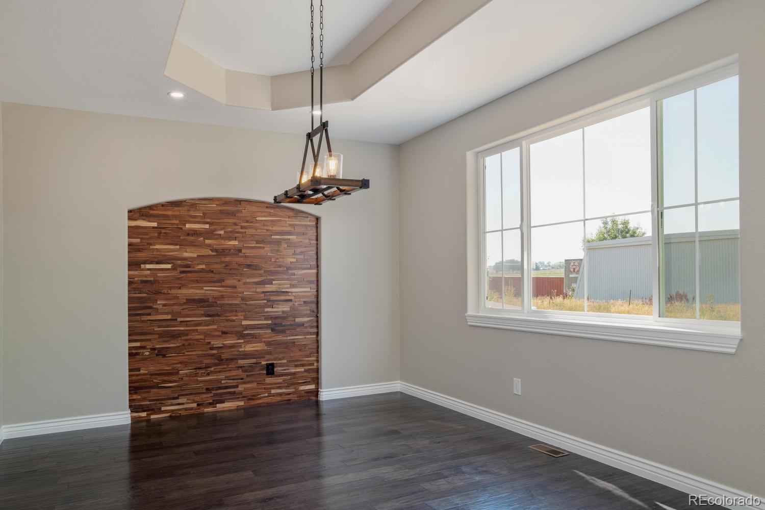 1726 Virginia Drive Fort Lupton, CO 80621 - Photo 8 of 36 a view of room with window and wooden floor