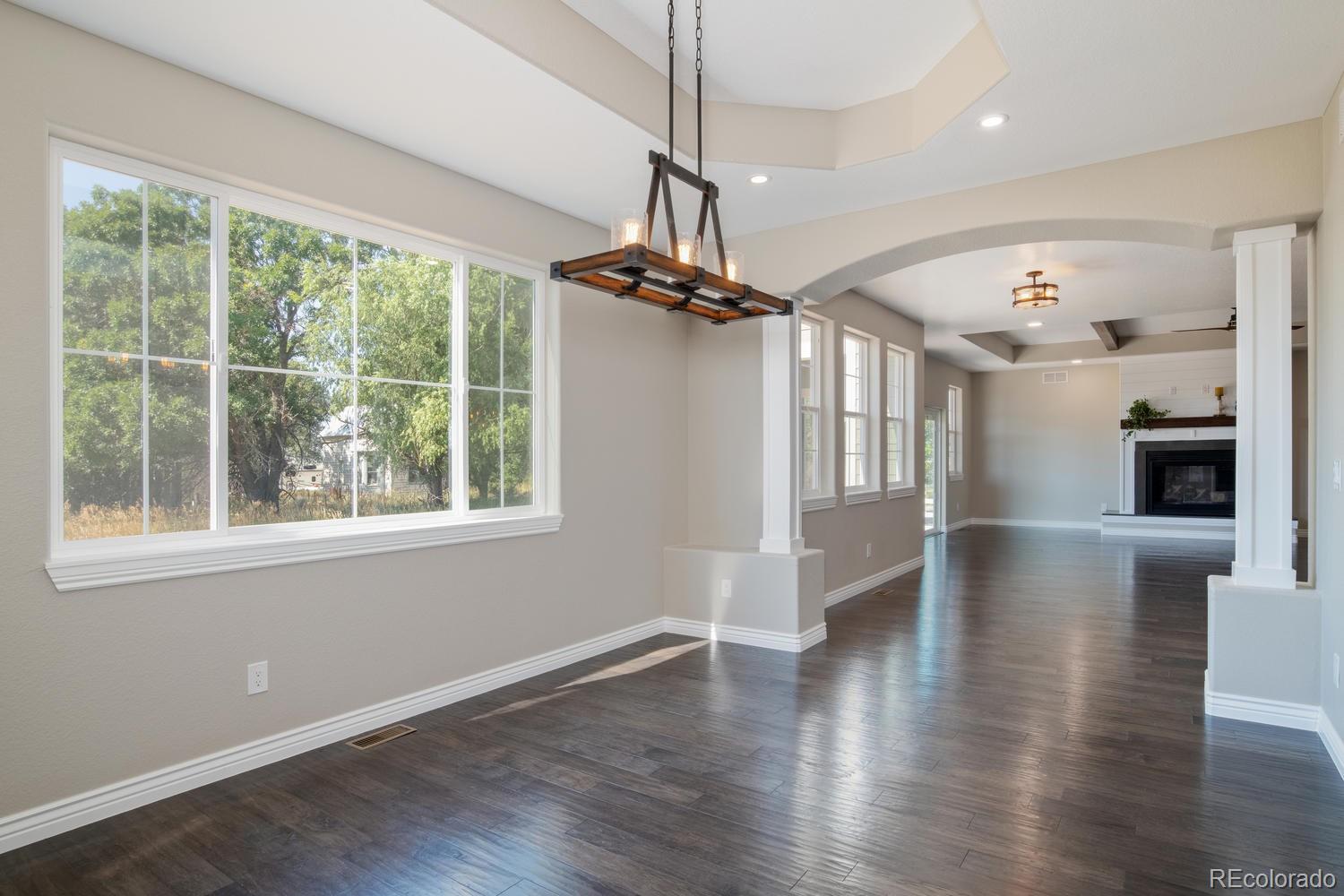 1726 Virginia Drive Fort Lupton, CO 80621 - Photo 9 of 36 a view of a livingroom with wooden floor and a ceiling fan