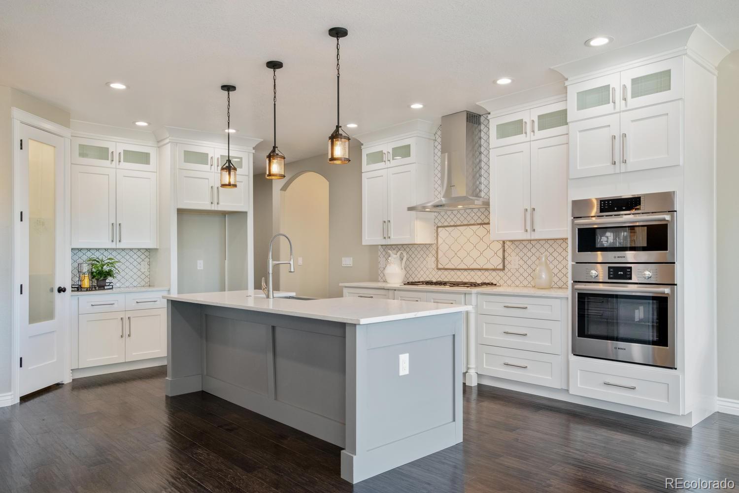 1726 Virginia Drive Fort Lupton, CO 80621 - Photo 10 of 36 a open kitchen with kitchen island white cabinets and stainless steel appliances