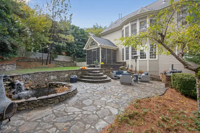 a view of a house with backyard porch and sitting area