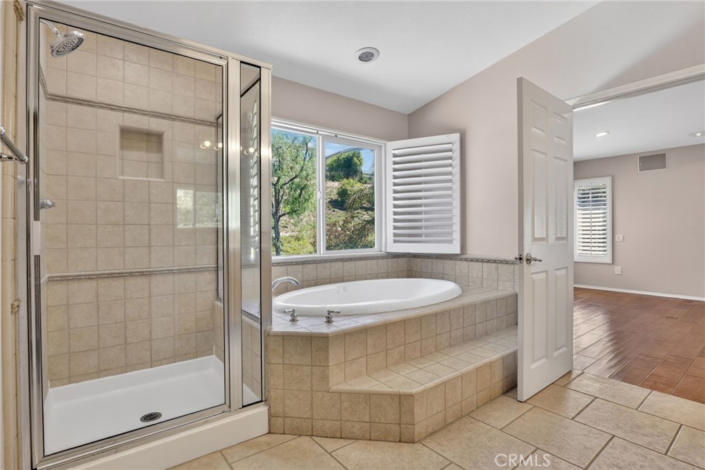 20543 Pesaro Porter Ranch Porter Ranch, CA 91326 - Photo 39 of 67 a bathroom with a granite countertop sink a mirror and a bathtub