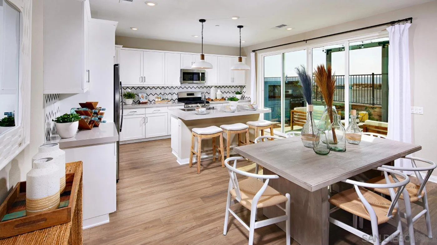 1672 Whitmore Loop, Unit HS PLAN 2 Chula Vista, CA 91913 - Photo 5 of 18 a kitchen with a table chairs stove and kitchen island