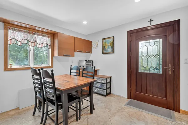 a dining room with furniture and window