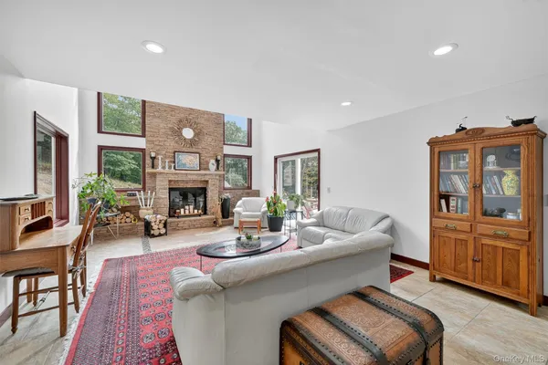 a living room with furniture a window and a fireplace