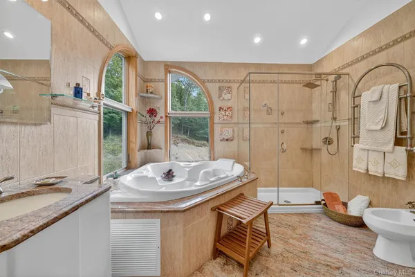 a white bath tub sitting in a bathroom next to a window