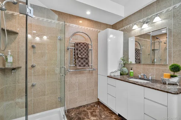 a bedroom with two beds and a desk