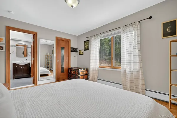 a living room with furniture a table and bookshelf