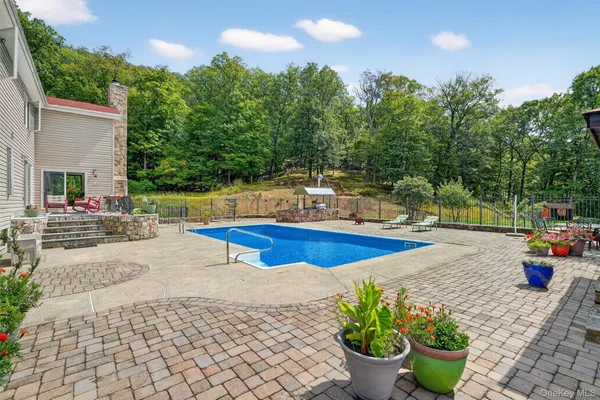 a view of a patio with table and chairs a barbeque with wooden fence