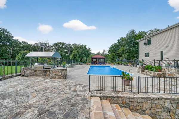 a view of a swimming pool with a lounge chair