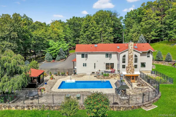 an aerial view of a house with swimming pool garden and patio