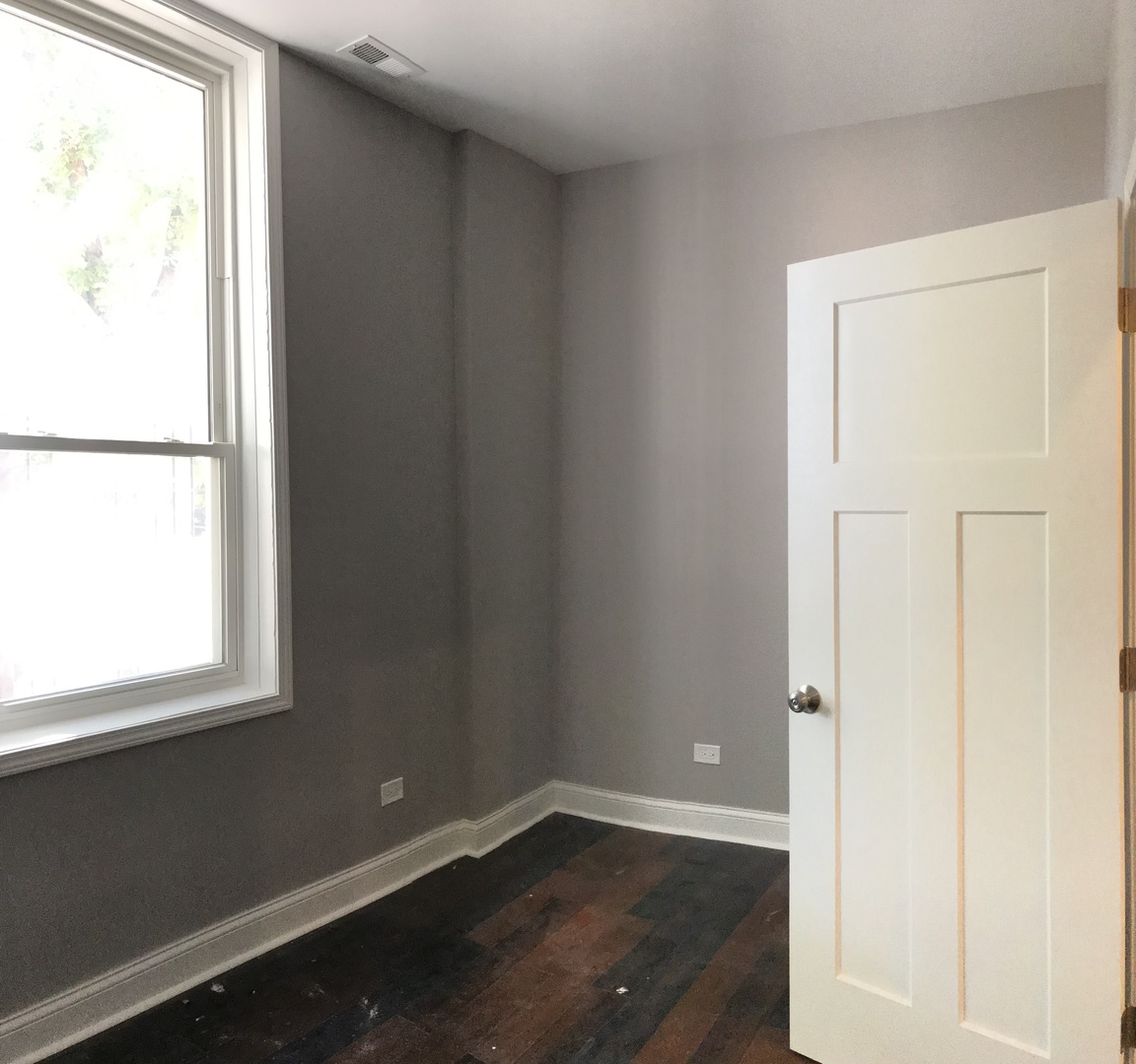 2734 West 18th Street, Unit 1F Chicago, IL 60608 - Photo 13 of 14 an empty room with wooden floor and a window