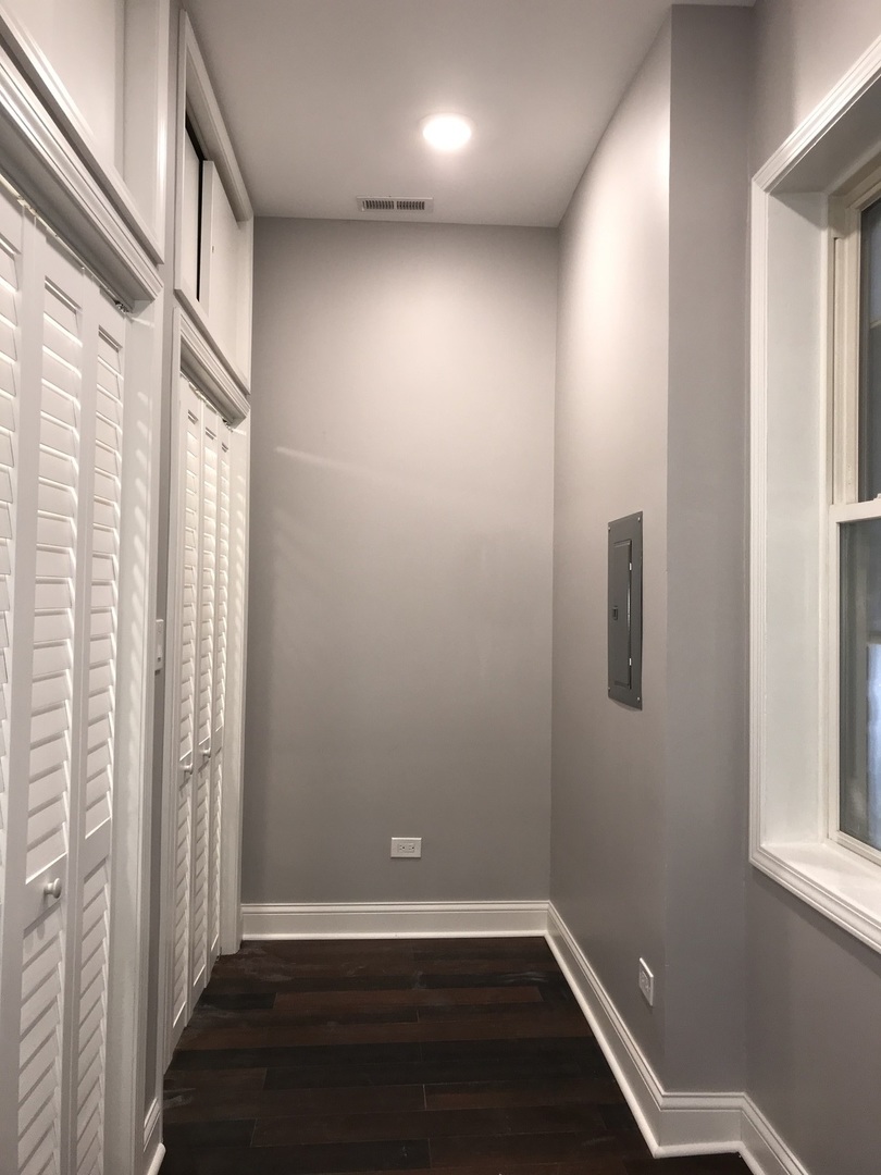 2734 West 18th Street, Unit 1F Chicago, IL 60608 - Photo 7 of 14 an empty room with wooden floor and windows