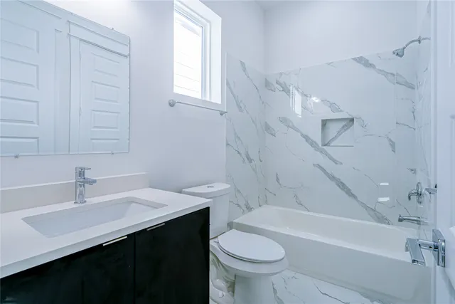 a bathroom with a sink a toilet and bathtub