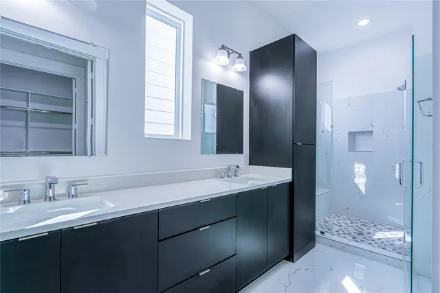 a bathroom with a sink a toilet and shower