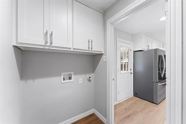 a view of a kitchen with refrigerator and cabinet