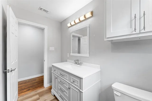 a bathroom with a sink vanity and a mirror