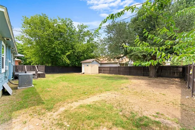 a backyard of a house with trees and outdoor seating