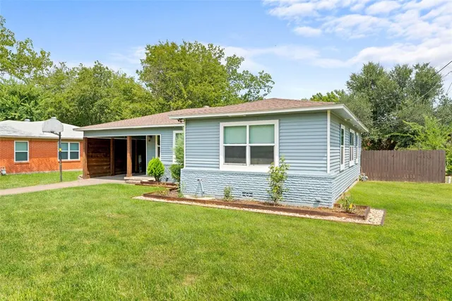 a front view of house with a garden and patio