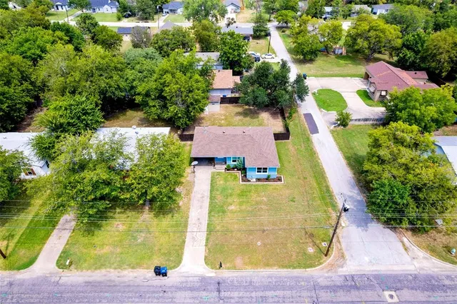 an aerial view of residential houses with yard