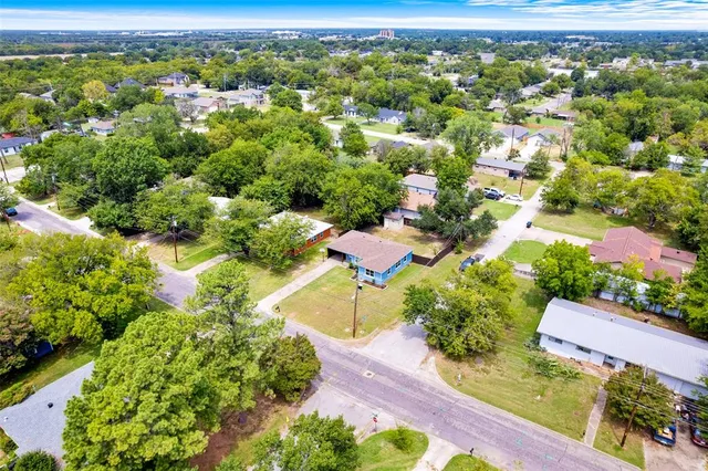 an aerial view of residential houses with outdoor space
