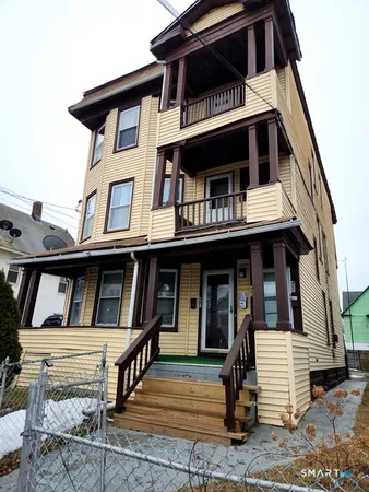 a view of small house with entrance gate