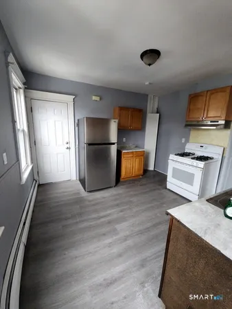 a kitchen with stainless steel appliances a refrigerator stove and microwave