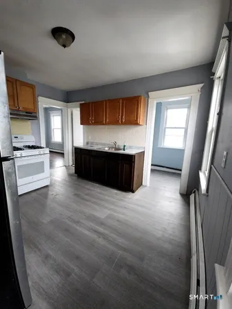 wooden floor in an empty room with a fireplace