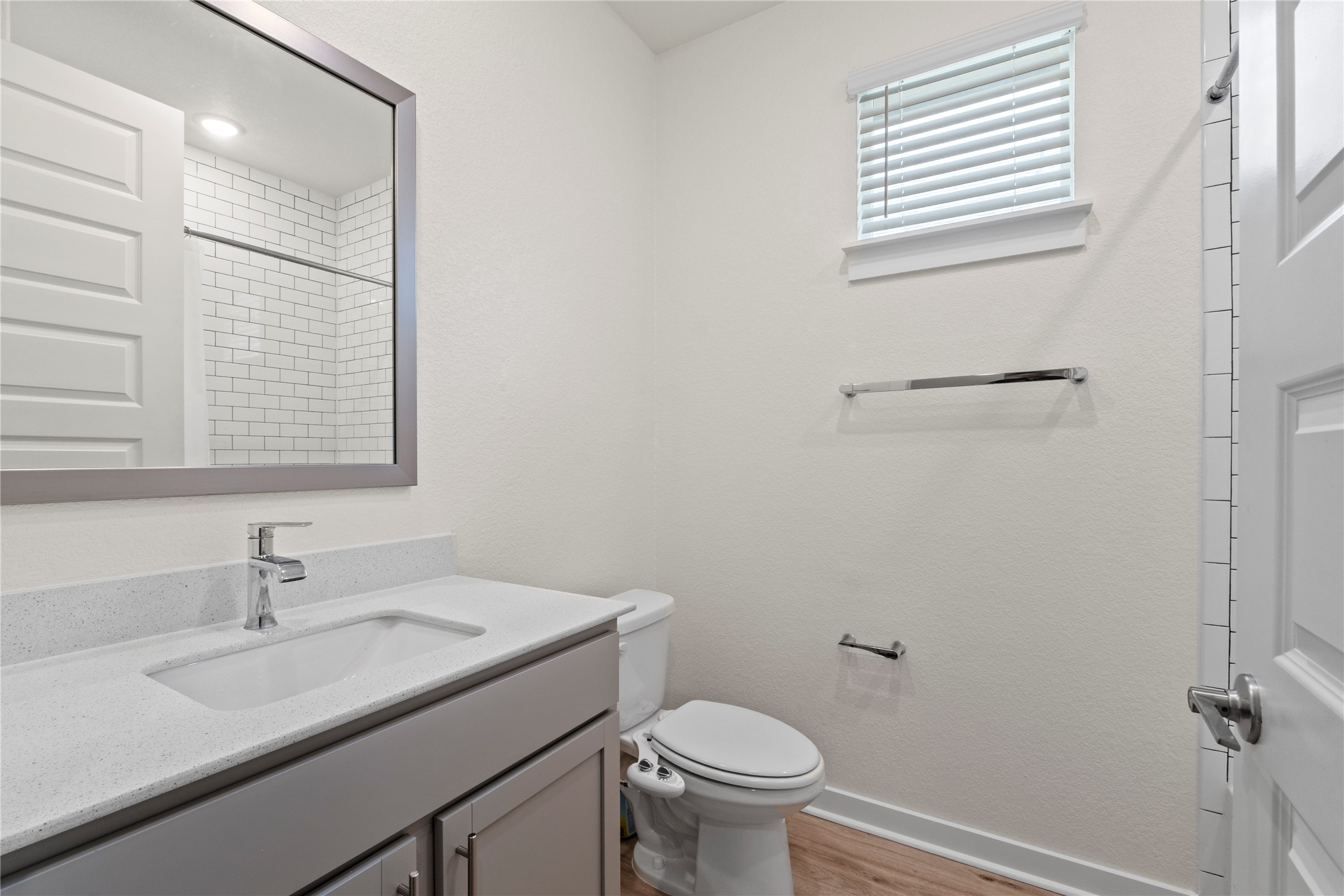 341 Peace Pipe Way Georgetown, TX 78628 - Photo 19 of 28 Secondary bathroom with framed mirrors, elongated toilet, quartz counters, undermount sink and waterfall faucet give this bathroom an elegant look with a functional element.