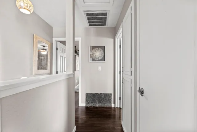 a view of a hallway with windows and stairs