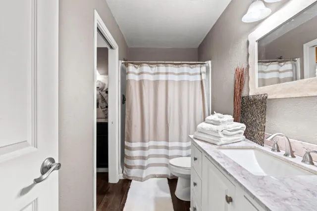 a bathroom with a sink toilet and shower