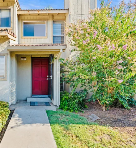 a view of entrance of the house with a yard