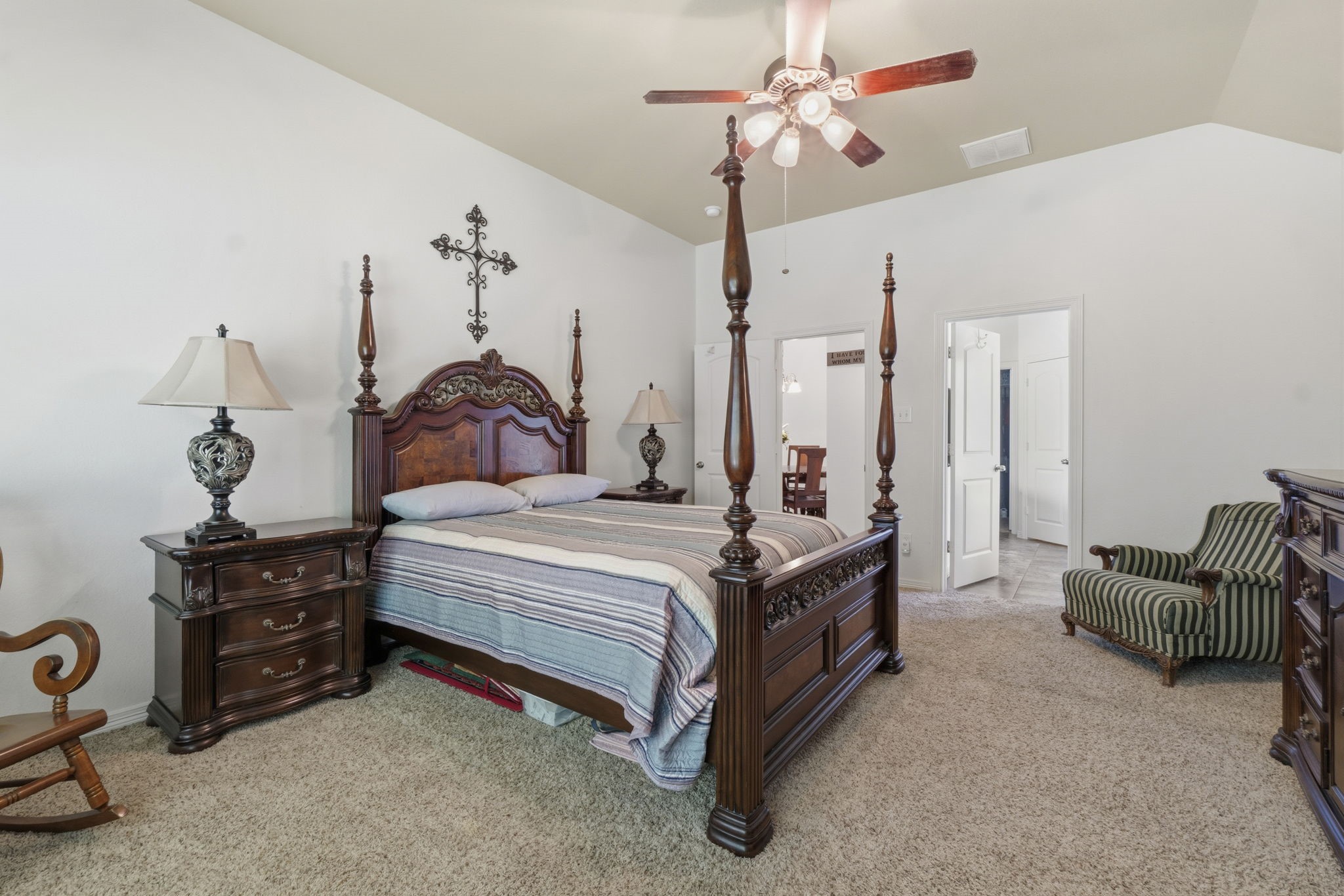 10802 Windswept Montgomery, TX 77356 - Photo 38 of 42 a spacious bedroom with a bed a chandelier and dresser