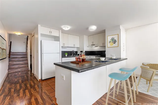 a kitchen with kitchen island a appliances a sink and a refrigerator